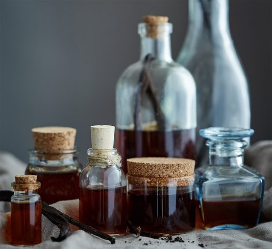 Bottles of home made vanilla extract with the vanilla beans in the bottle