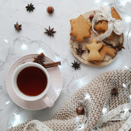 Table with cookies, spices and a cup of tea giving an impression of baking and vanilla 